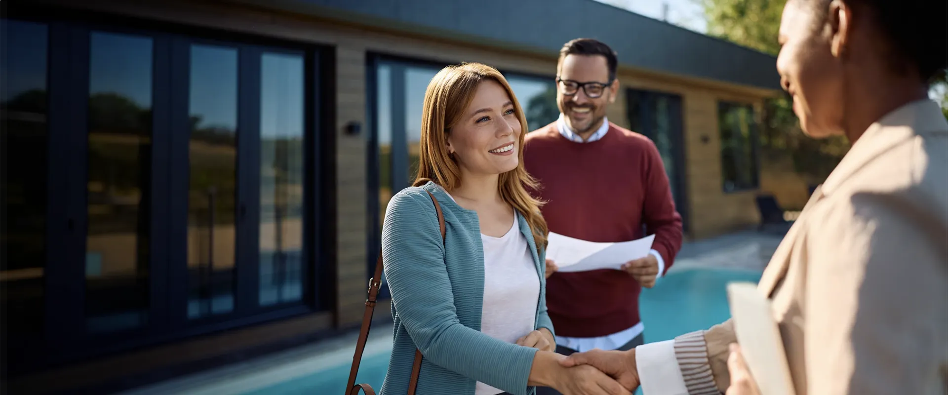 Handshake between Fiber partners beside a pool