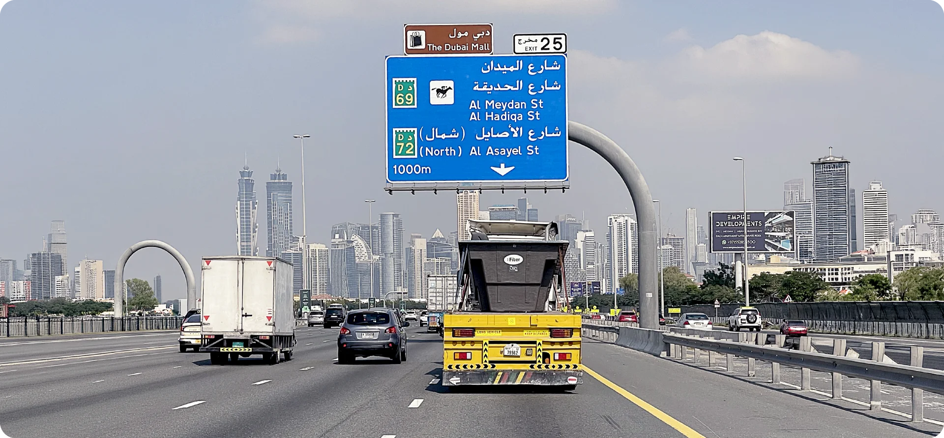 Highway in Dubai with Arabic road sign and skyline in the background, representing Fiber's international expansion