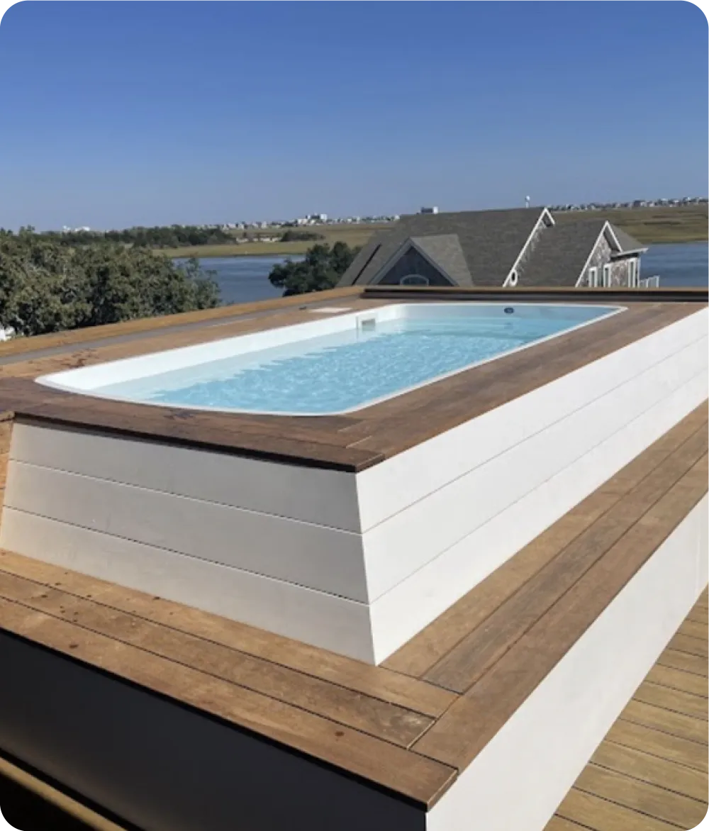Completed fiberglass pool design with water on townhome rooftop deck