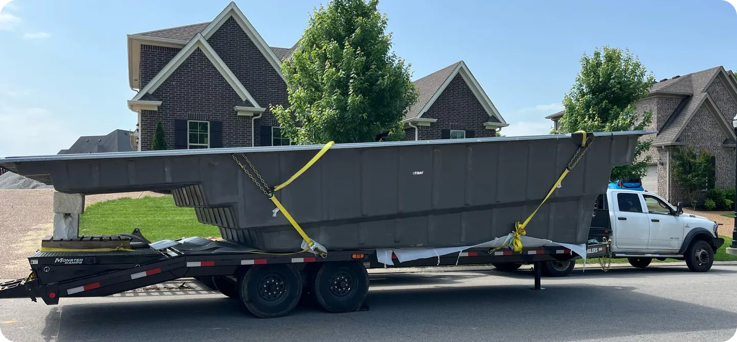 Fiberglass pools loaded onto flatbed transport truck for delivery from factory to jobsite
